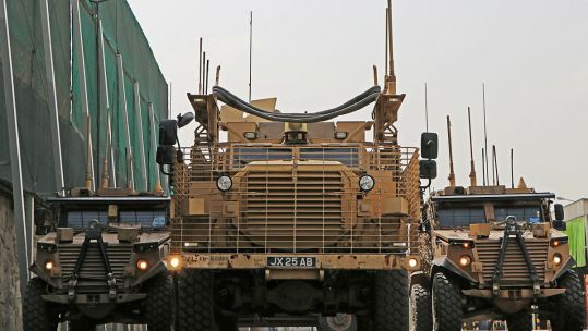 Two Foxhound Light Protection Patrol Vehicles flanking a Mastiff Protected Patrol Vehicle