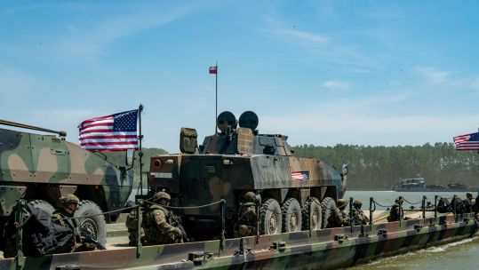 Two Polish KTO Rosomak Infantry Fighting Vehicles board an American raft to cross the Danube River, near Bordusani, Romania, Ex Saber Guardian 23 060623 CREDIT US DEPARTMENT OF DEFENSE
