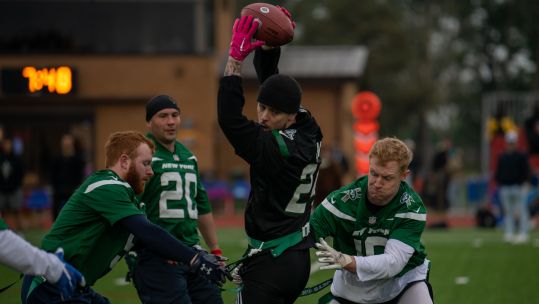 U.K. Armed Forces members try to remove a flag from a U.S. Air Force Senior Airman during a flag football game at Royal Air Force Lakenheath