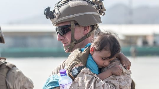 US Marine calms an infant 