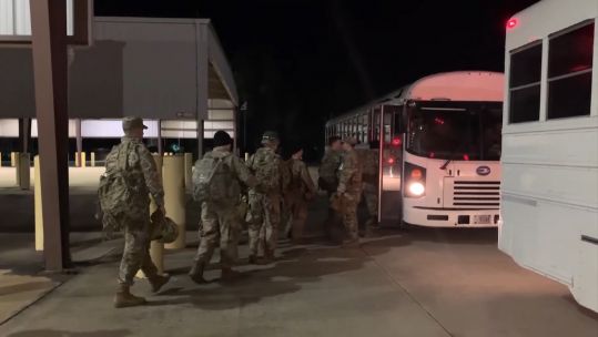 US Marines board bus as part of deployment to secure US embassy in Baghdad.