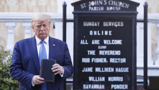 US President Donald J. Trump poses with a bible outside St. John's Episcopal Church after delivering remarks in the Rose Garden at the White House in Washington, DC 010620 CREDIT PA.jpg