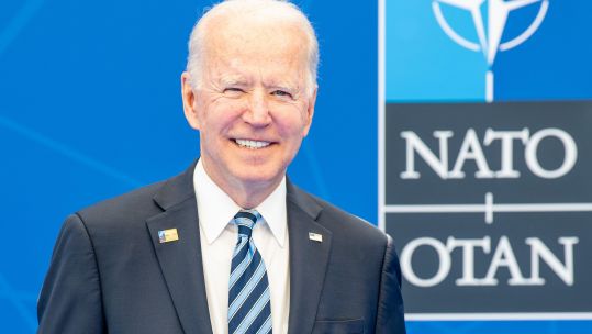 US President Joe Biden during Brussels NATO summit with logo in background 140621 CREDIT SIPA US ALAMY.jpg