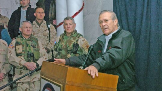 Donald Rumsfeld speaks to soldiers in Iraq in 2004 