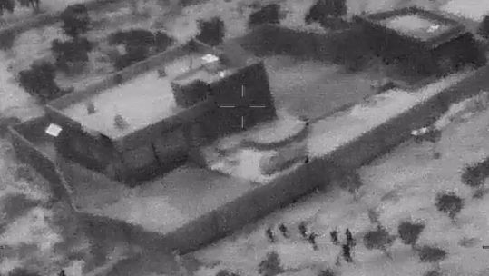 US forces are shown approaching the building before the raid (Picture: US Department of Defense). 