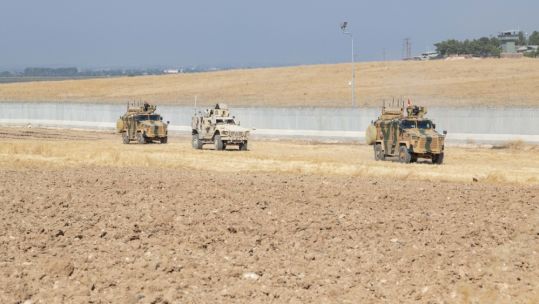US and Turkish military forces conduct ground patrol in north-east Syria