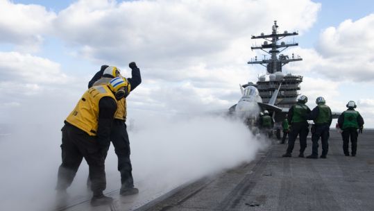 US personnel prepare to launch FA-18 Super Hornet from deck of USS Dwight D Eisenhower