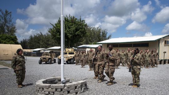 Cover Image: US troops during a flag-raising ceremony at Manda Bay Airfield (Picture: US Department of Defense).