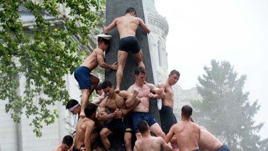 US Naval Academy plebes form a human pyramid around the 21-foot tall Herndon Monument in May 2017 CREDIT US Navy