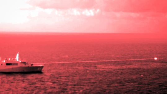 USS Portland test-fires Laser Weapon System Demonstrator at floating target in Gulf of Aden 141221 CREDIT US DEPARTMENT OF DEFENSE