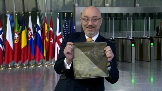 Ukraine's defence minister Oleksii Reznikov showing reporters a napkin showing two fast jets at a Nato summit in Belgium 