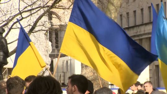 Ukrainian flags being held up by anti-war protesters in Whitehall