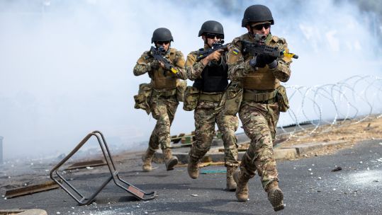 Ukrainian trainees practising urban fighting techniques during UK training programme
