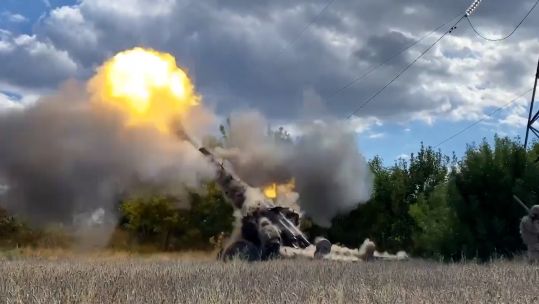 Ukrainian troops firing an artillery round