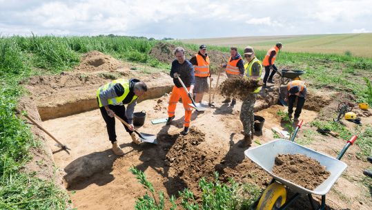 Ukrainian veterans digging alongside British Dutch German Belgian and Australian veterans CREDIT Waterloo Uncovered and Chris van Houts