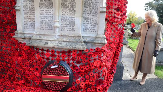 The Queen attached the final poppy to complete the cascade of 10,000 poppies draping the church tower at St Bartholomew's Church 