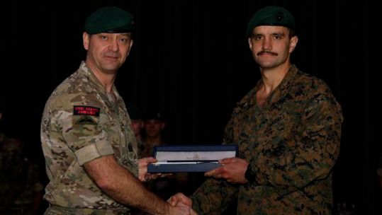 US Marines Corps Captain Brown receiving his green beret from the Commando All-Arms Course (Picture: Royal Marines Commando Training Centre X). 
