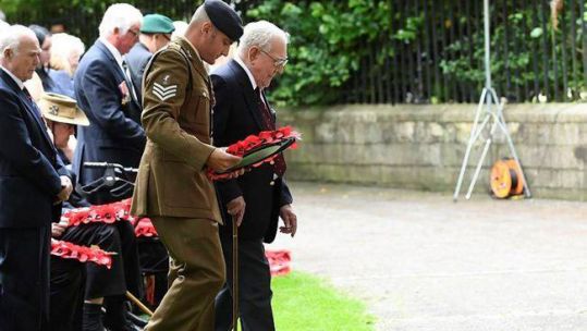 Veteran laying wreath