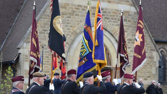 Veterans holding flags at the funeral of Douglas Parker, a D-Day veteran who died aged 98 
