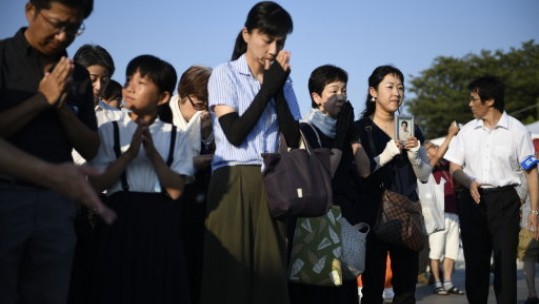 Visitors lay pray for the atomic bomb victims in front of the cenotaph at the Hiroshima Peace Memorial Park (Picture: PA).