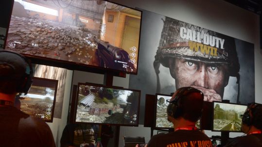 Visitors to games expo play Call of Duty WWII