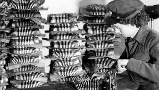 WAAF armourer belting up ammunition
