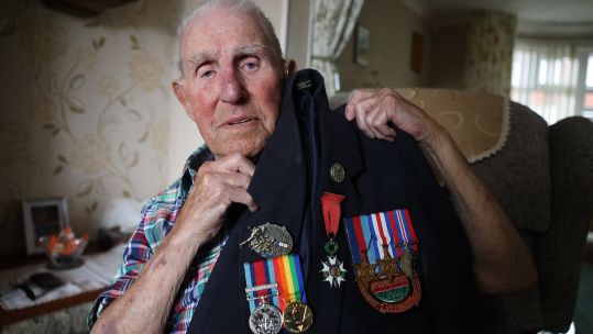 WW2 veteran Ken Cooke shows off his medals