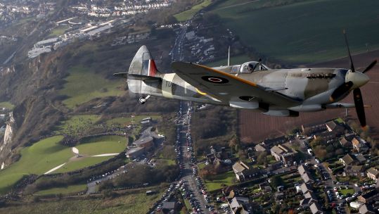 World War II Spitfire, flies over the Battle of Britain Memorial in Folkestone, Kent, in a tribute to the fallen on Remembrance 