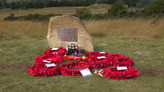 Wreaths were laid on Cleeve Hill as part of the service to remember the victims of a Second World War airplane crash that killed seven airmen 260824 CREDIT Julian Wellings