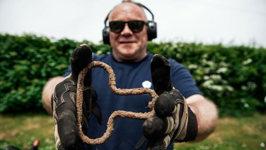 A jubilant veteran finds a parachute pull that belonged to one of Easy Company from the 'Band Of Brothers' US Paratroopers from WW2_2019 CREDIT Photography by Harvey Mills ARPS