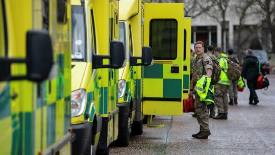 ambulances being driven by military personnel at