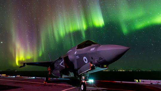 F-35B lightning jets flight deck of Prince of Wales under the northern lights (Picture: MOD).