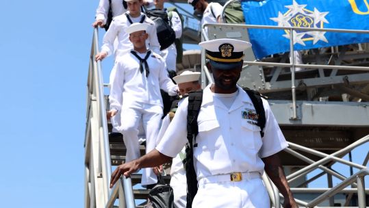 crew_of_uss_dwight_d_eisenhower_disembark_at_naval_station_norfolk_140724_credit_us_department_of_defense.jpg	