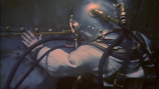A WWII US Navy Diver Surveys a sunken ship