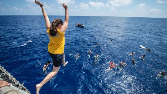 Yeoman 1st Class Margaret Royal from the USA, participates in a swim call aboard the USS Halsey. Picture: PJF Military Collection / Alamy  