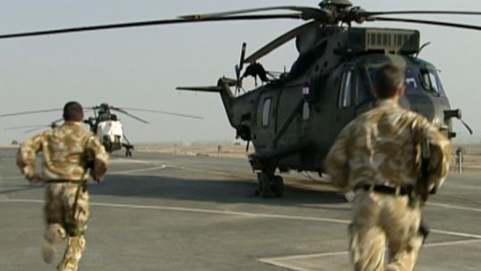 Soldiers running towards helicopter in Iraq