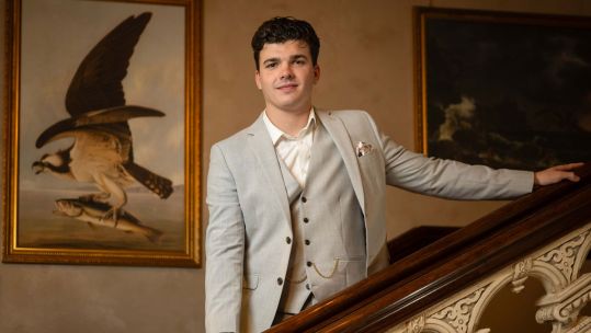LCpl Harry Clark poses on the stairs during final episode of series two of The Traitors CREDIT BBC Studio Lambert Paul Chappells