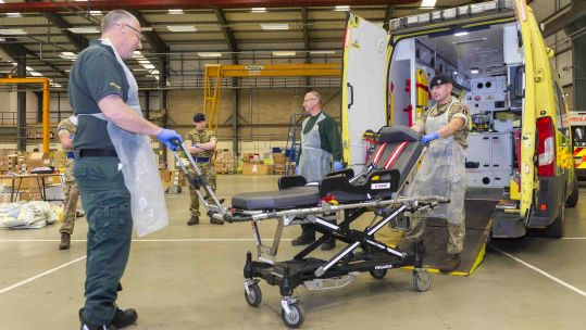 NHS paramedic shows Queen's Dragoons Guard Trooper equipment used in ambulance CREDIT MOD 170420.jpg
