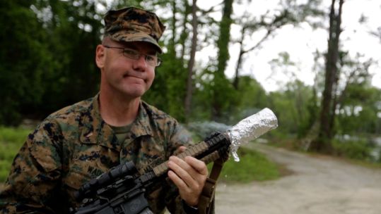 Retired US Marine Corps Chief Warrant Officer 5 Christian Wade attempts to cook bacon using the heat of his gun's suppressor 6 CREDIT US Department of Defense