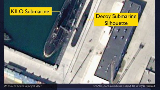 This image shows a Russian Kilo-class sub in port alongside a painted silhouette (Picture: Crown Copyright/CNES 20924, Distribution AIRBUS DS)