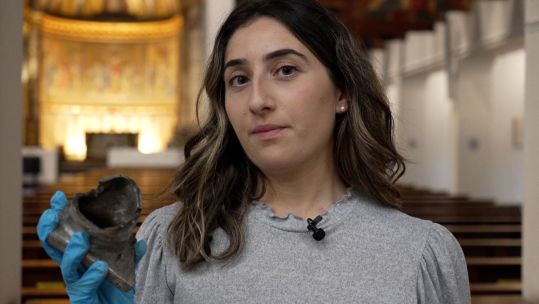 Sofie Cacoyannis holds a fragment of the V-1 bomb that destroyed the Guards' Chapel in June 1944 CREDIT BFBS