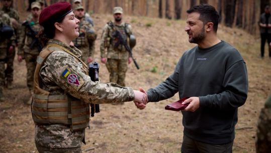 Ukrainian President Volodymyr Zelenskyy presenting a combat award to a female soldier in Kupiansk (Picture: Defence of Ukraine).