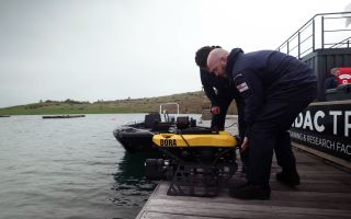 Two Royal Navy divers prepare to launch Defender on a practice run (Picture: Royal Navy)
