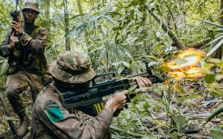 A para opens fire with blank ammo from his SA80 L85 A2, but operating in the jungle is about surviving just as much as engaging the enemy