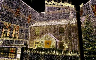 The house with all of its 300,000 lights sparkling bright in the darkness