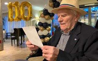 Norman, an RAF veteran, reads a letter from Princess Anne, Patron of the charity 