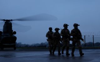 The rangers walk in front of a Chinook during Exercise Hyperion Storm