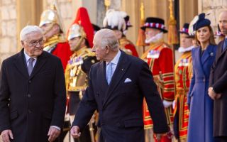 King Charles shares a few words with German president Frank-Walter Steinmeier while being escorted by the Guard of Honour at Windsor Castle