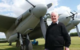 Colin Bell pictured with a de Havilland Mosquito - Colin flew the bomber variant in raids over Germany