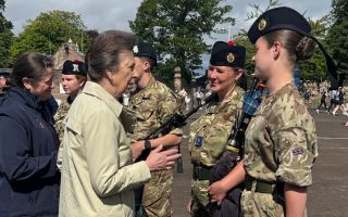 Princess Anne meets with a performer of the Royal Edinburgh Military Tattoo at a rehearsal at Redford Barracks